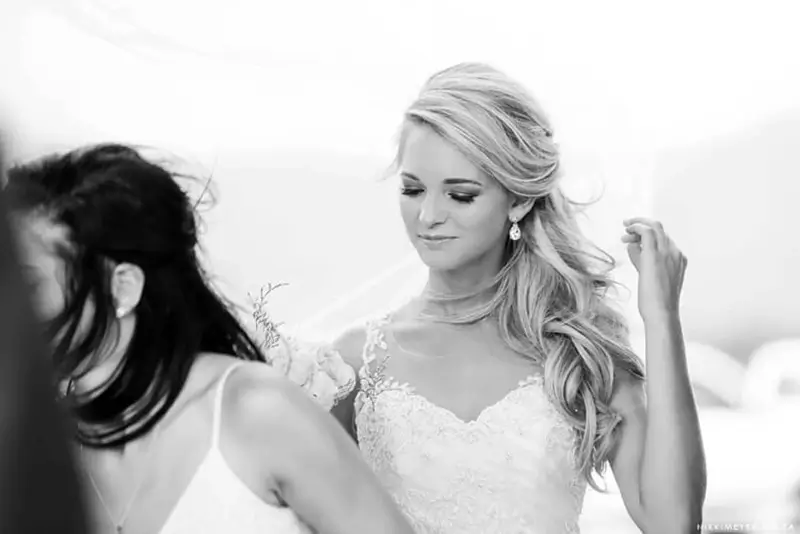 Bride getting dressed after doing hair and makeup in Cape town during wedding